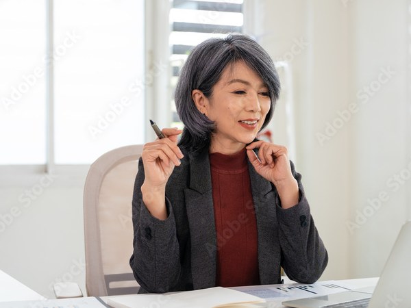 An executive reviewing her plan at her desk
