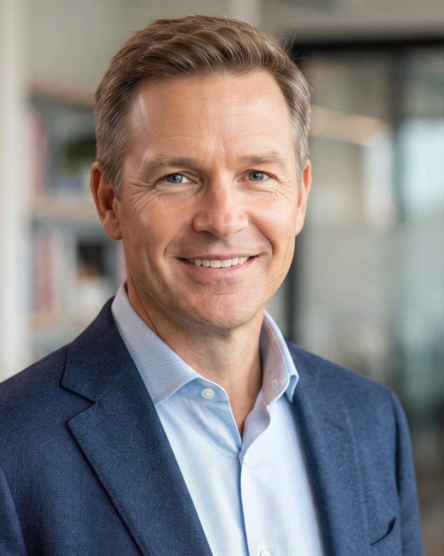 A senior executive smiling in a bright modern office